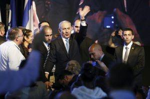 Israeli Prime Minister Netanyahu waves to supporters at party headquarters in Tel Aviv